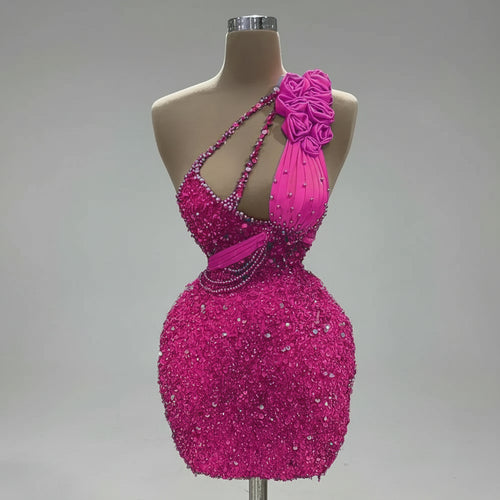 Pink beaded dress on a mannequin with 'CENXUAN' branding, indoor setting.