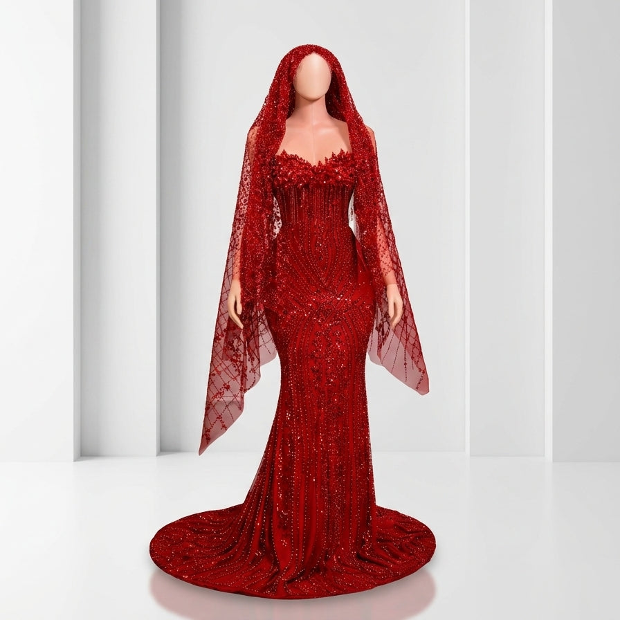Red evening gown with a sheer overlay on a white background